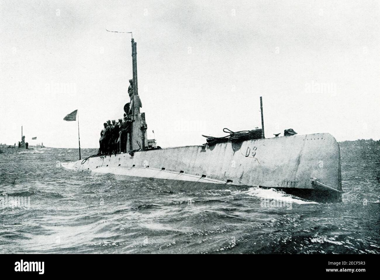 This photo by  E Muller Jr. from World War I shows an american submarine on the surface. Robert Enrique Muller sometimes credited as Enrique Muller, Jr. and as E. Muller, was an official photographer for the United States Navy, and an author. He took photos of military ships in action. Stock Photo