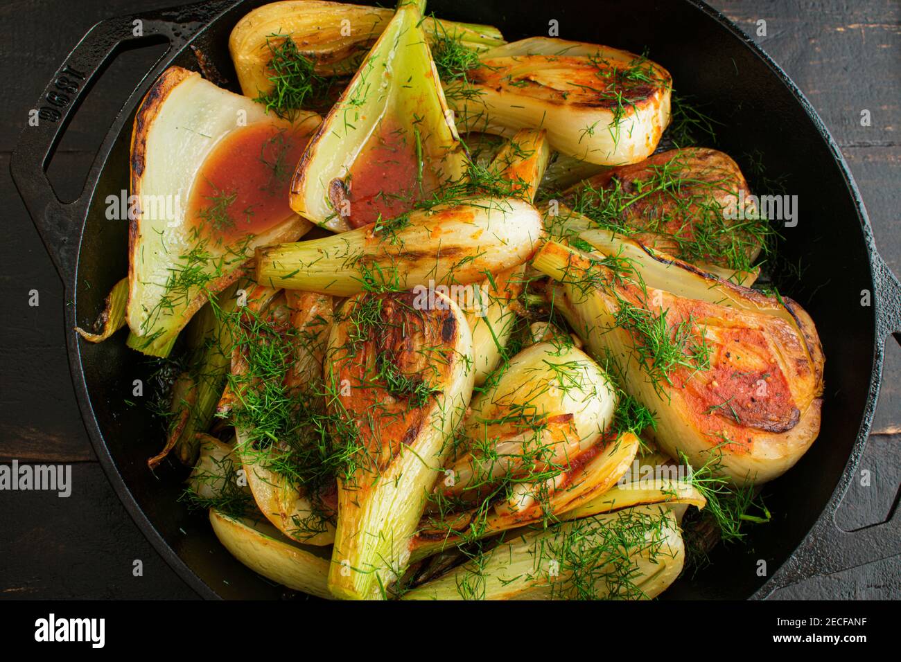 Sautéed Fennel with Garlic and Tomato Sauce Sliced fennel bulbs in a