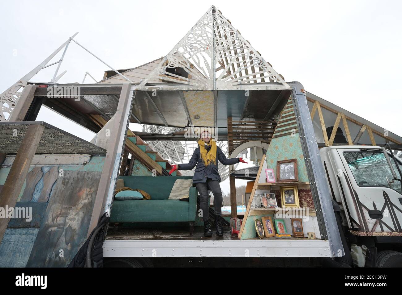 A performer recites a monologue while standing inside the mobile