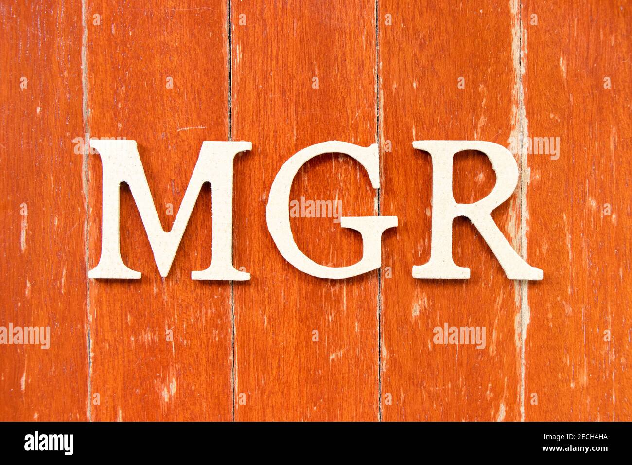 Alphabet letter in word mgr (abbreviation of manager) on old red color