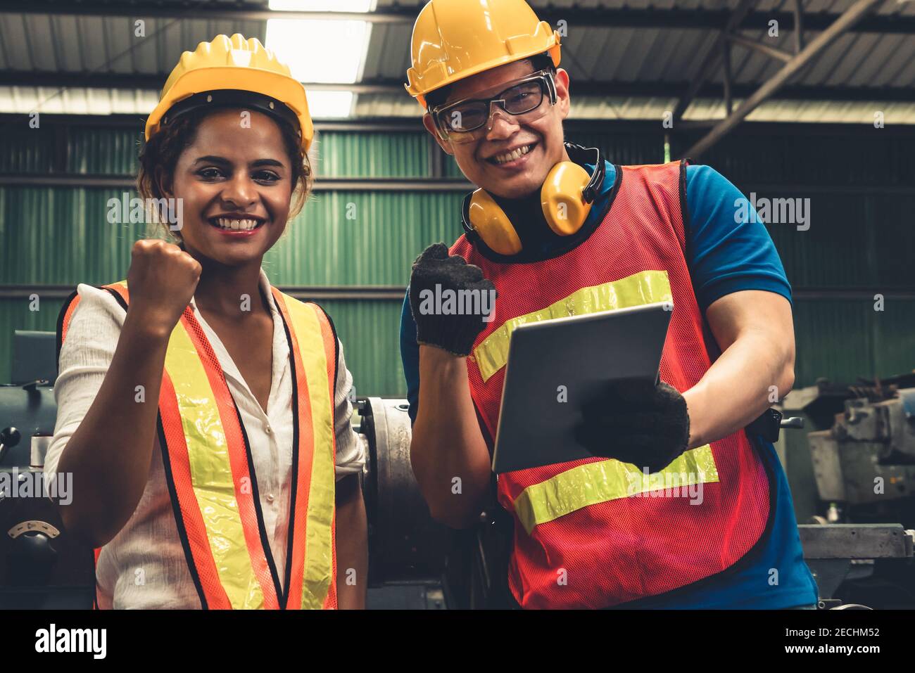 Two skillful factory engineer or worker happy portrait looking at camera . Industrial people and manufacturing labor concept . Stock Photo