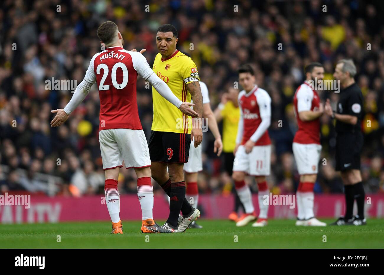 Soccer Football - Premier League - Arsenal vs Watford - Emirates Stadium, London, Britain - March 11, 2018   Watford's Troy Deeney talks to Arsenal's Shkodran Mustafi            Action Images via Reuters/Tony O'Brien    EDITORIAL USE ONLY. No use with unauthorized audio, video, data, fixture lists, club/league logos or 'live' services. Online in-match use limited to 75 images, no video emulation. No use in betting, games or single club/league/player publications.  Please contact your account representative for further details. Stock Photo