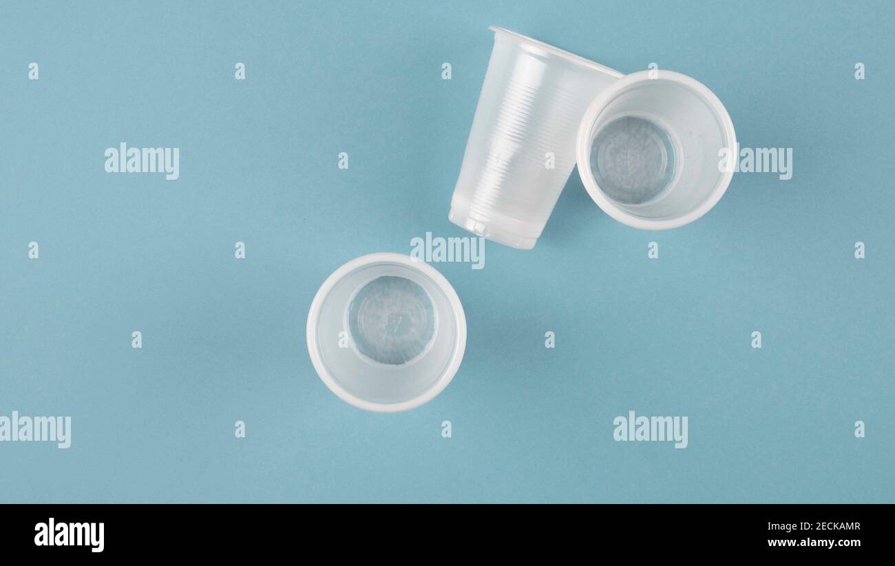 white plastic cups on a blue background Stock Photo