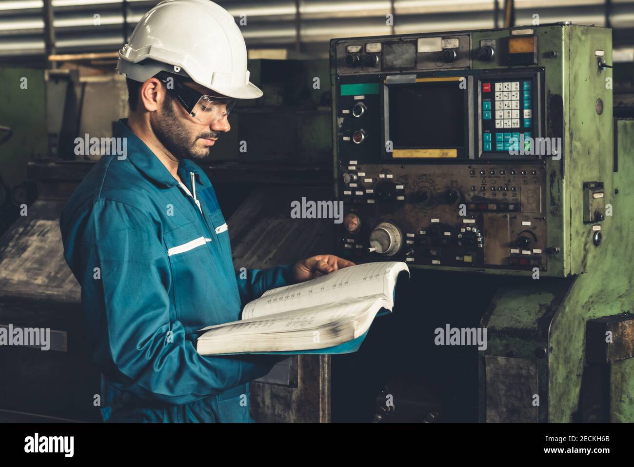 Skillful factory worker working with clipboard to do job procedure
