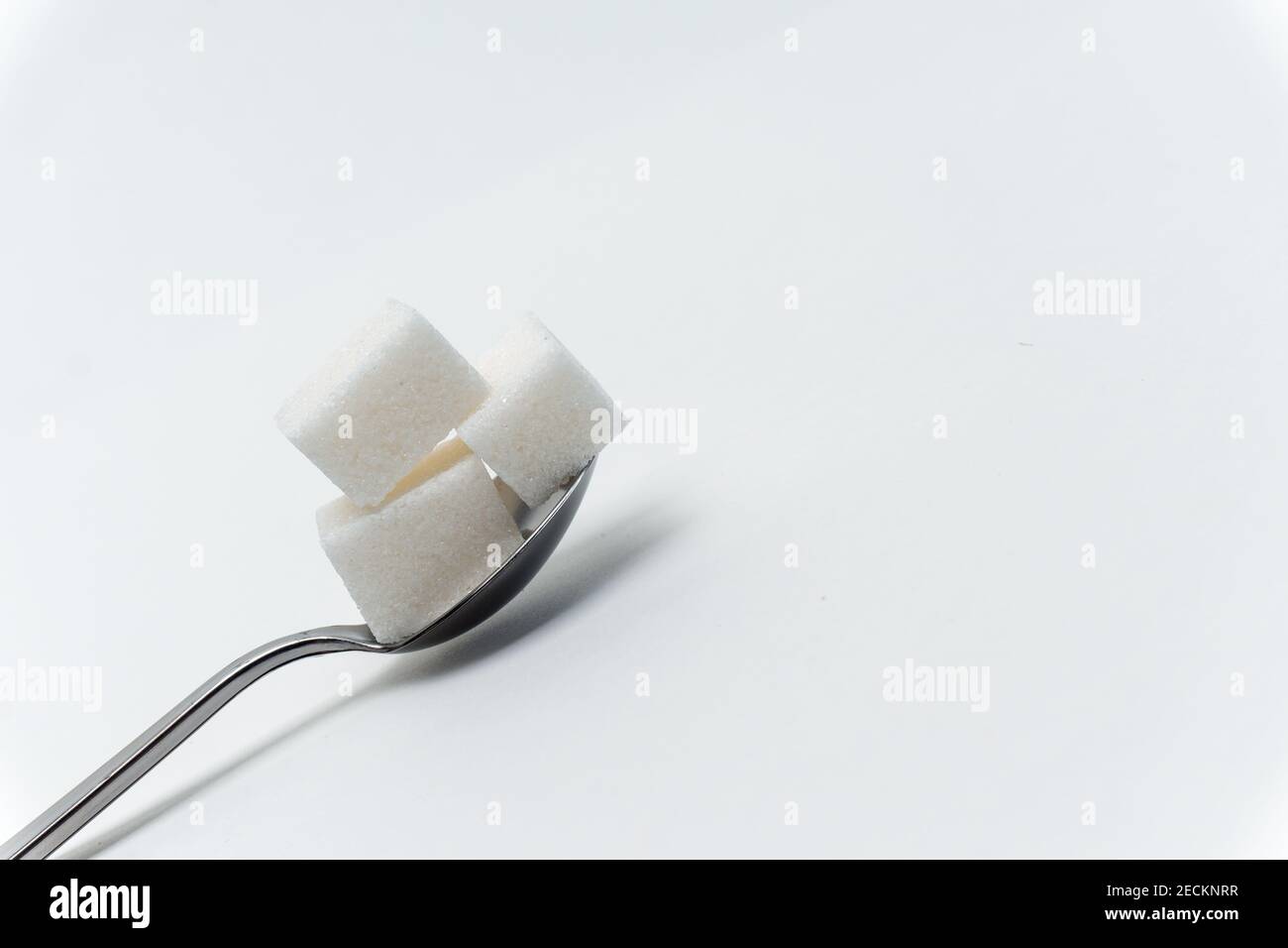 sugar cubes in a teaspoon sweets calorie ingredient Glucose Stock Photo