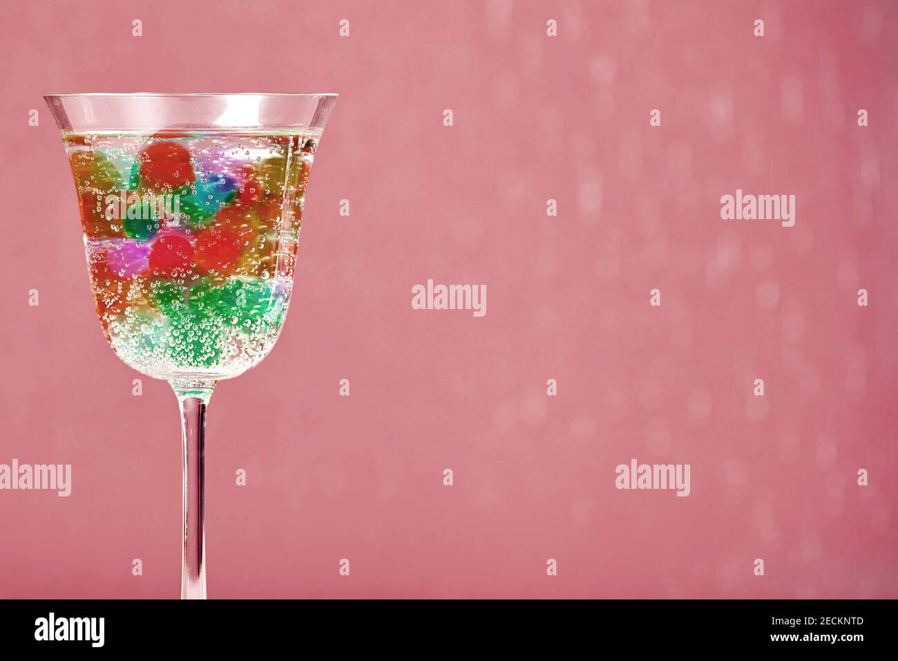 Shiny cocktail glass with fresh alcohol drink and jelly bubbles inside