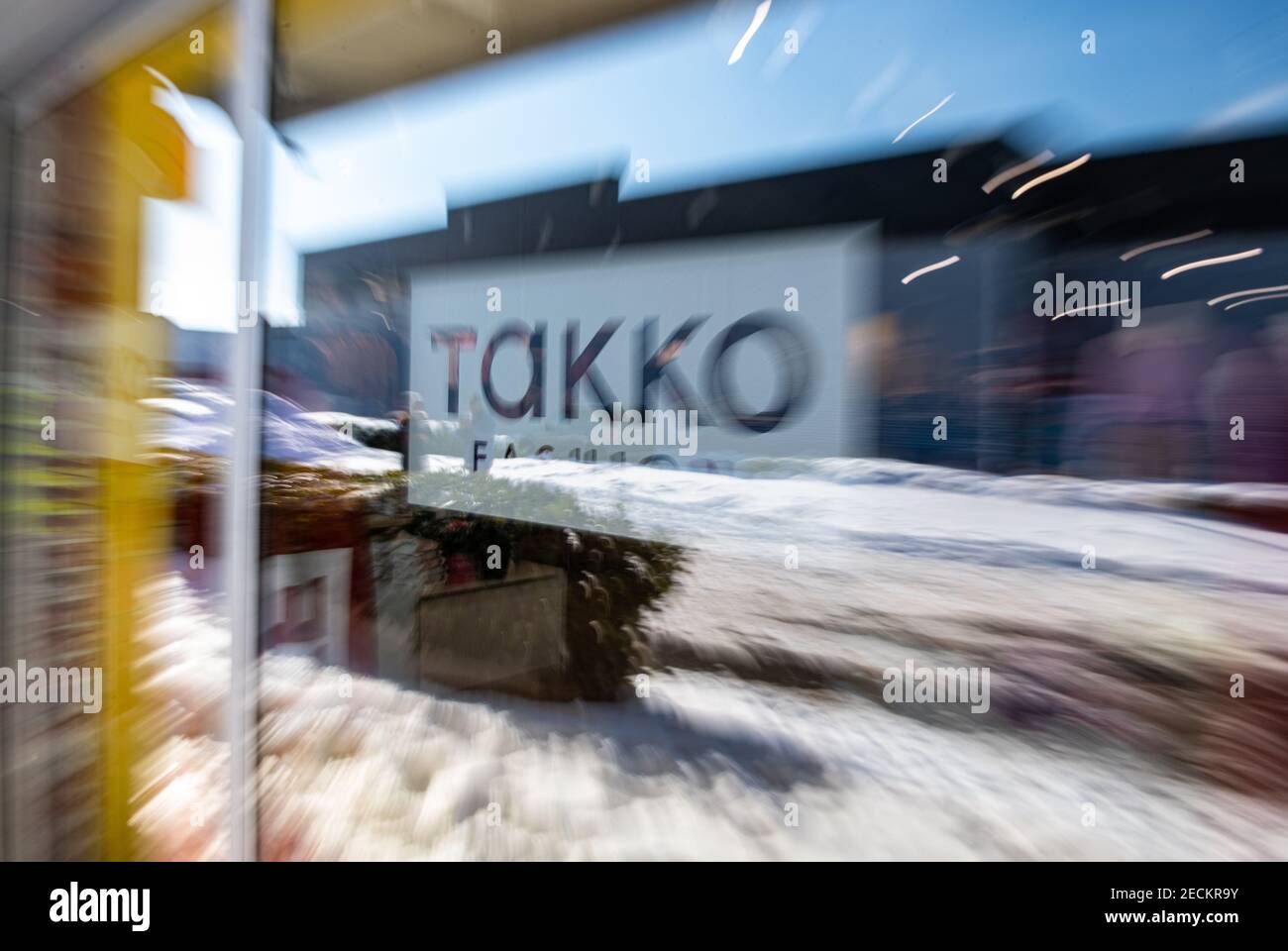 Telgte, Germany. 12th Feb, 2021. The Takko logo of a Takko Fashion store in  Telgte is stuck on a glass pane. (Taken with a long exposure time - zoomed). Takko ModeMarkt GmbH &