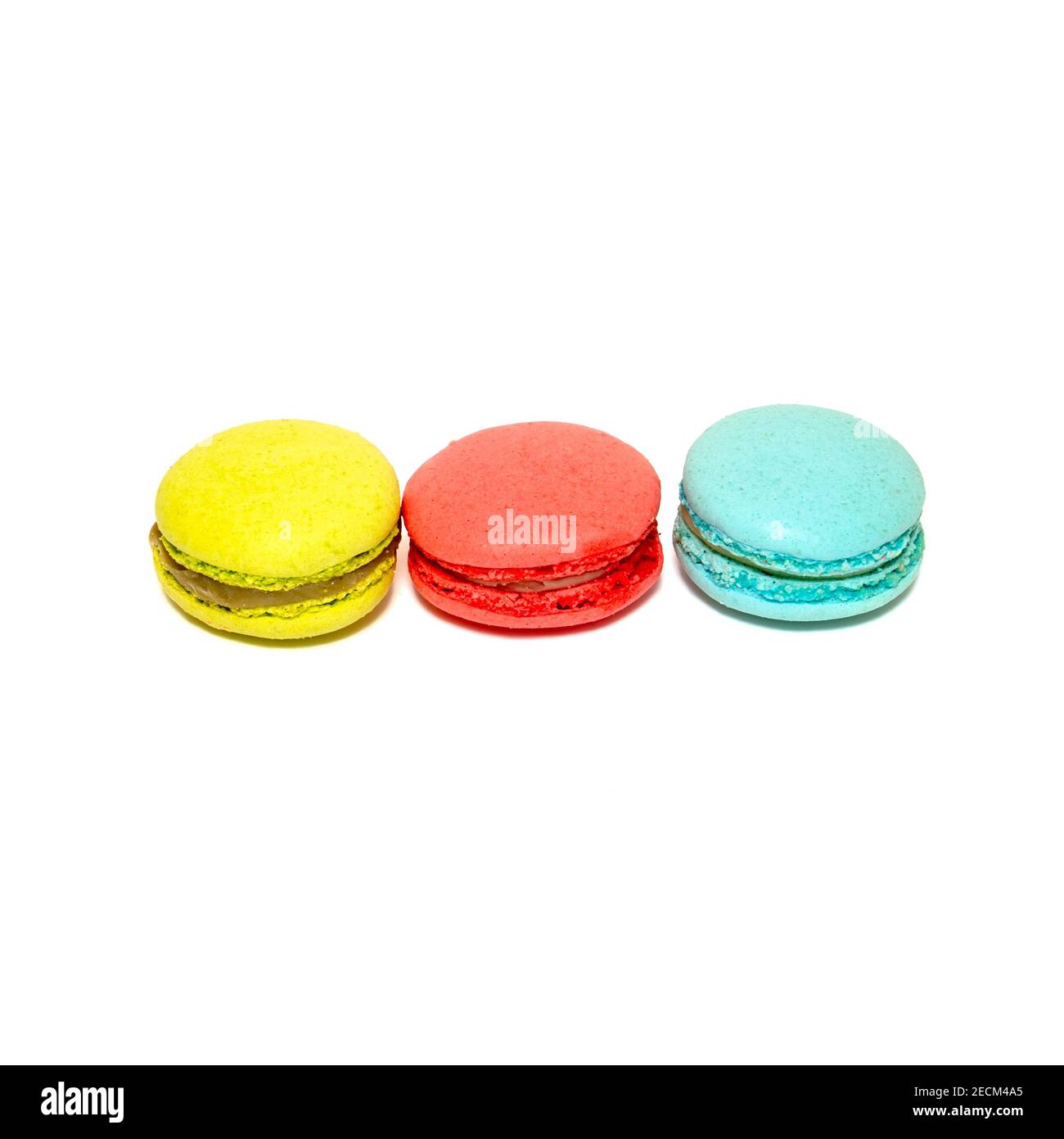 Yellow Red Blue Macaroons isolated in white background. Colorful french macarons close-up. Tasty sweet color macaroon, bakery concept Stock Photo