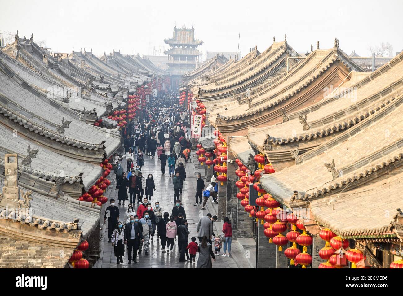 Beijing, China's Shanxi Province. 12th Feb, 2021. Visitors tour the Pingyao Ancient Town on the first day of the Lunar New Year in Jinzhong, north China's Shanxi Province, Feb. 12, 2021. Credit: Liang Shengren/Xinhua/Alamy Live News Stock Photo