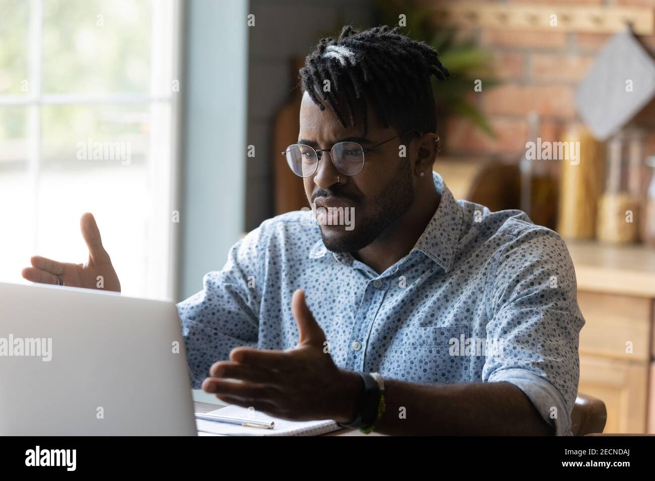 Close up angry African American man having problem with laptop Stock Photo