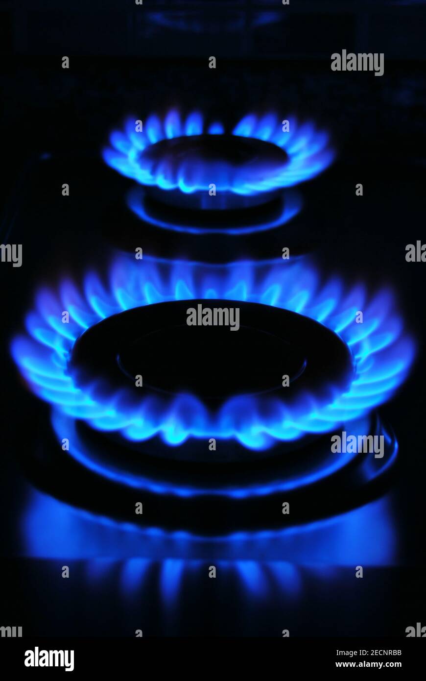 Gas stove burning in the kitchen, blue flames isolated on black