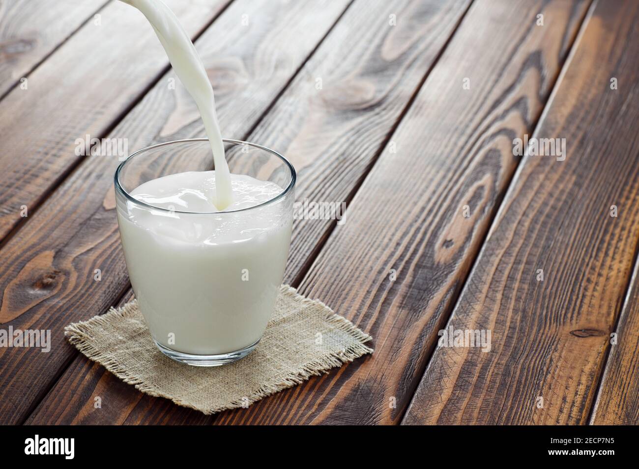 milk pouring into glass Stock Photo