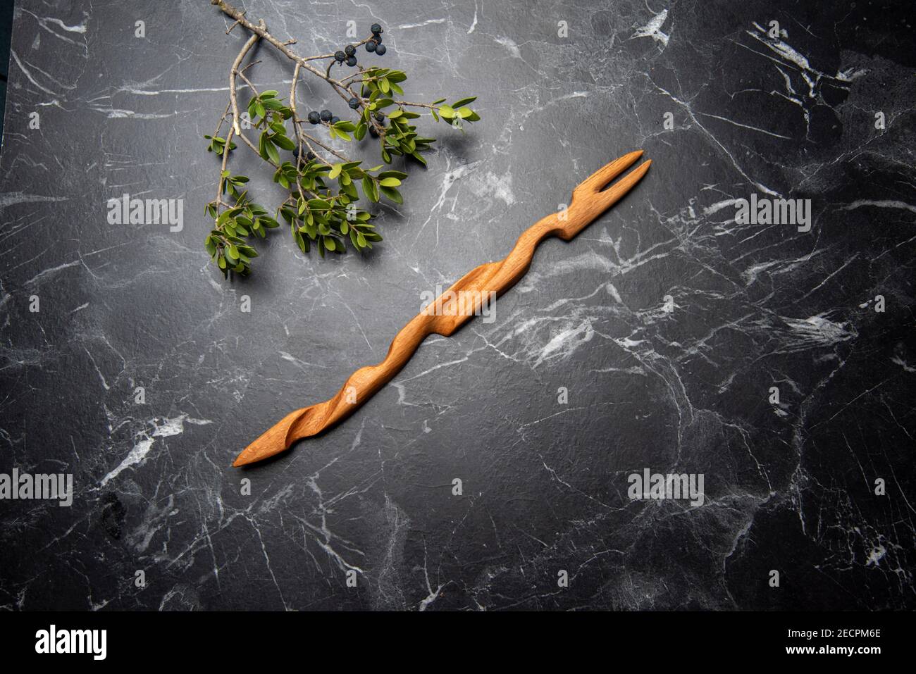 handcraft wooden fork on black marble Stock Photo