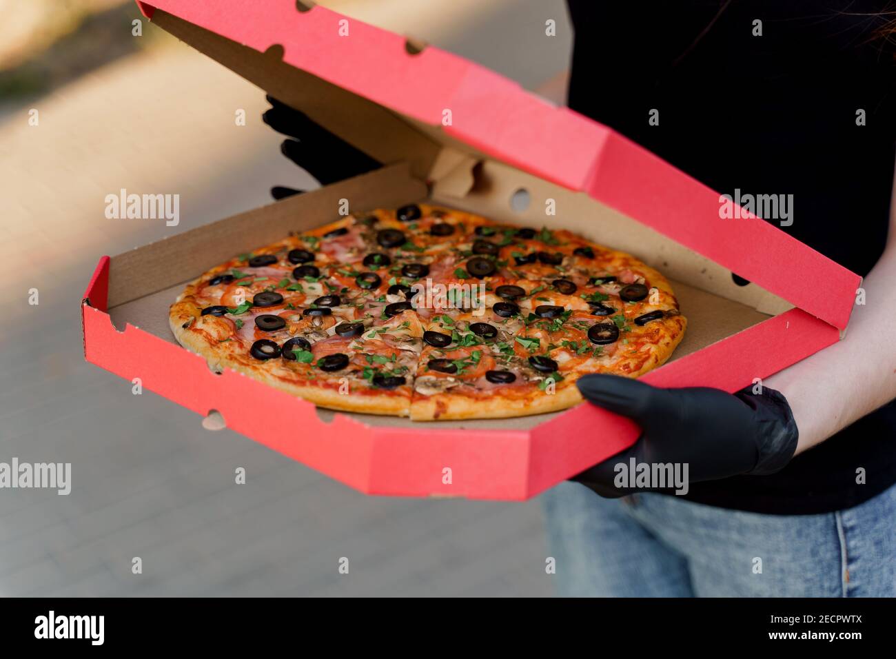 Pizza with salami and cheese in cardboard box. Safety delivery in black  medical gloves from restaurant. Quarantine for stop coronavirus covid-19  Stock Photo - Alamy