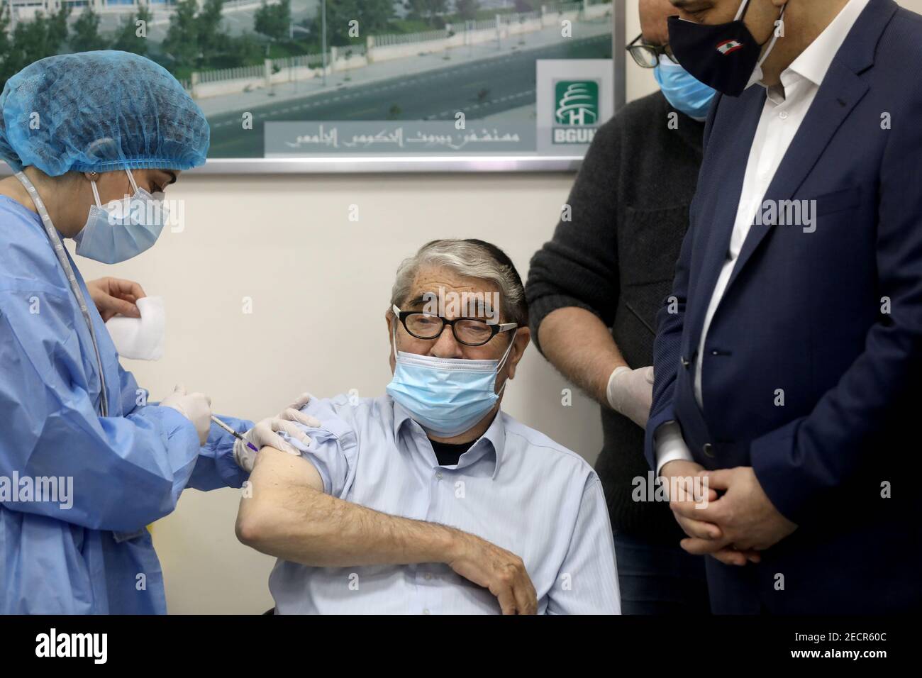 Salah Tizani, 92, known as Abou Salim and one of Lebanon?s first TV celebrities, receives a dose of the Pfizer/BioNTech vaccine against the coronavirus disease (COVID-19) during a coronavirus vaccination campaign at Rafik Hariri University Hospital, in Beirut, Lebanon February 14, 2021. REUTERS/Mohamed Azakir Stock Photo