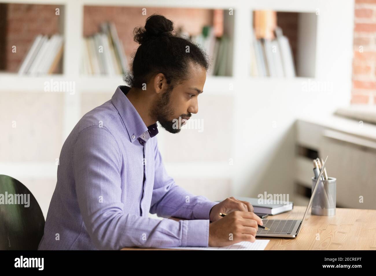 Pensive African American man work on laptop Stock Photo