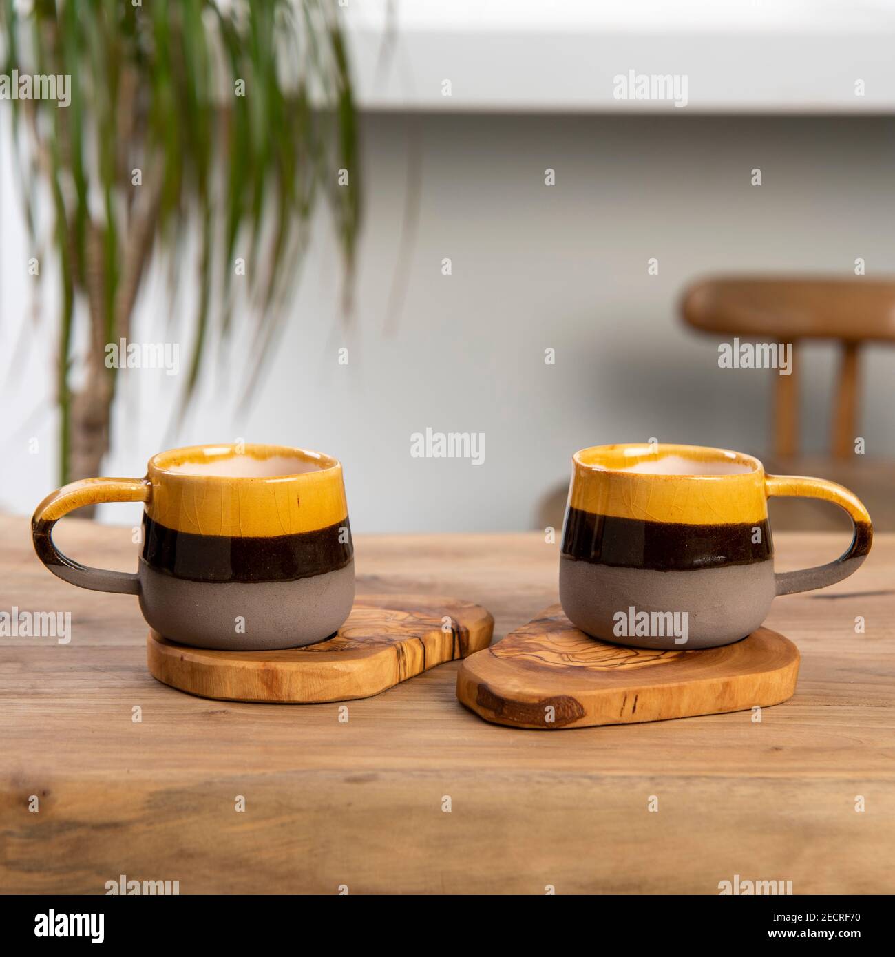 colorful handmade ceramic coffee cups on table Stock Photo