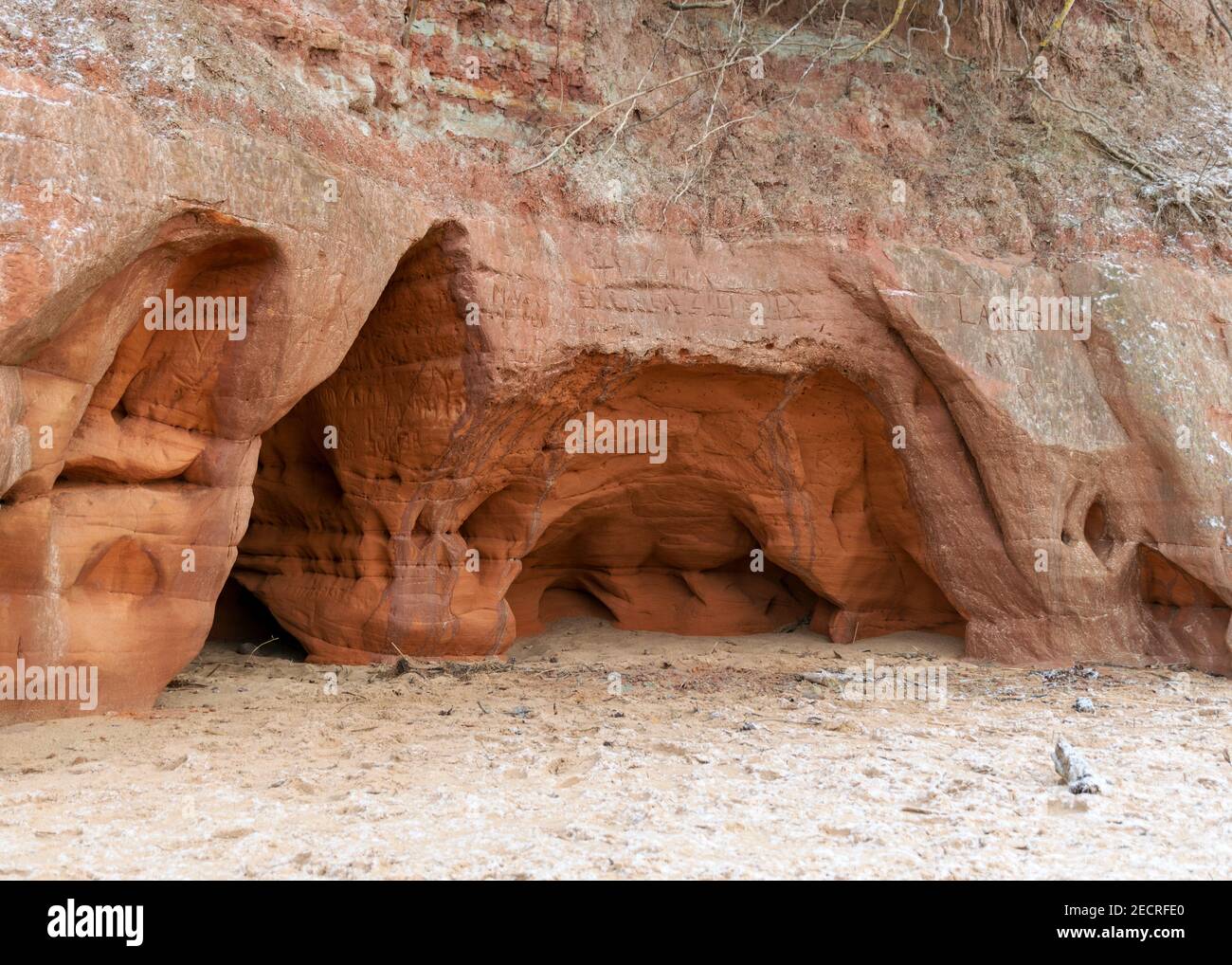Sea cliff with Devonian sandstone outcrops. During the storm, niches and caves were washed away