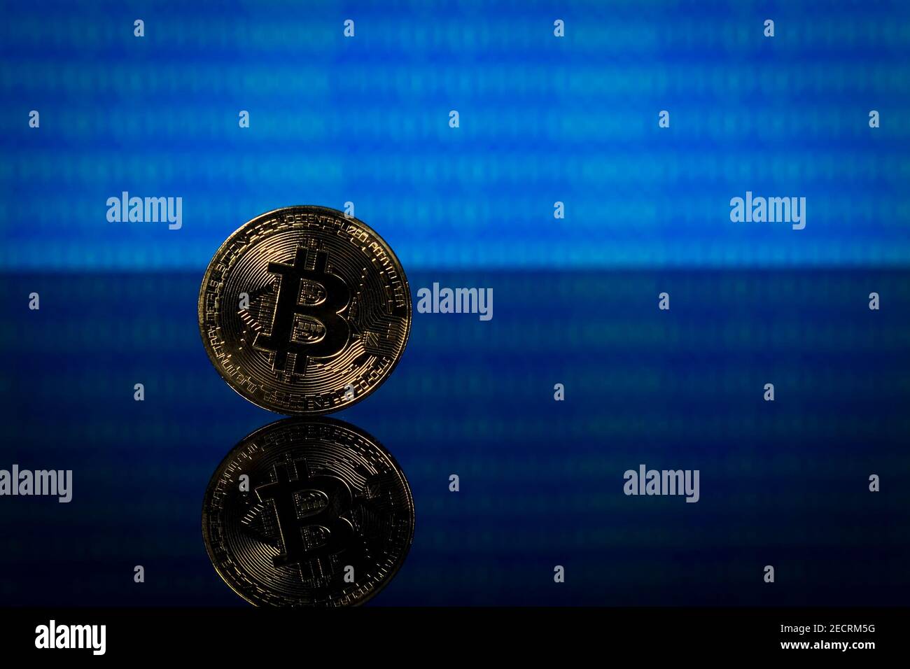 Golden bitcoin, binary code on a blue background Stock Photo - Alamy image.