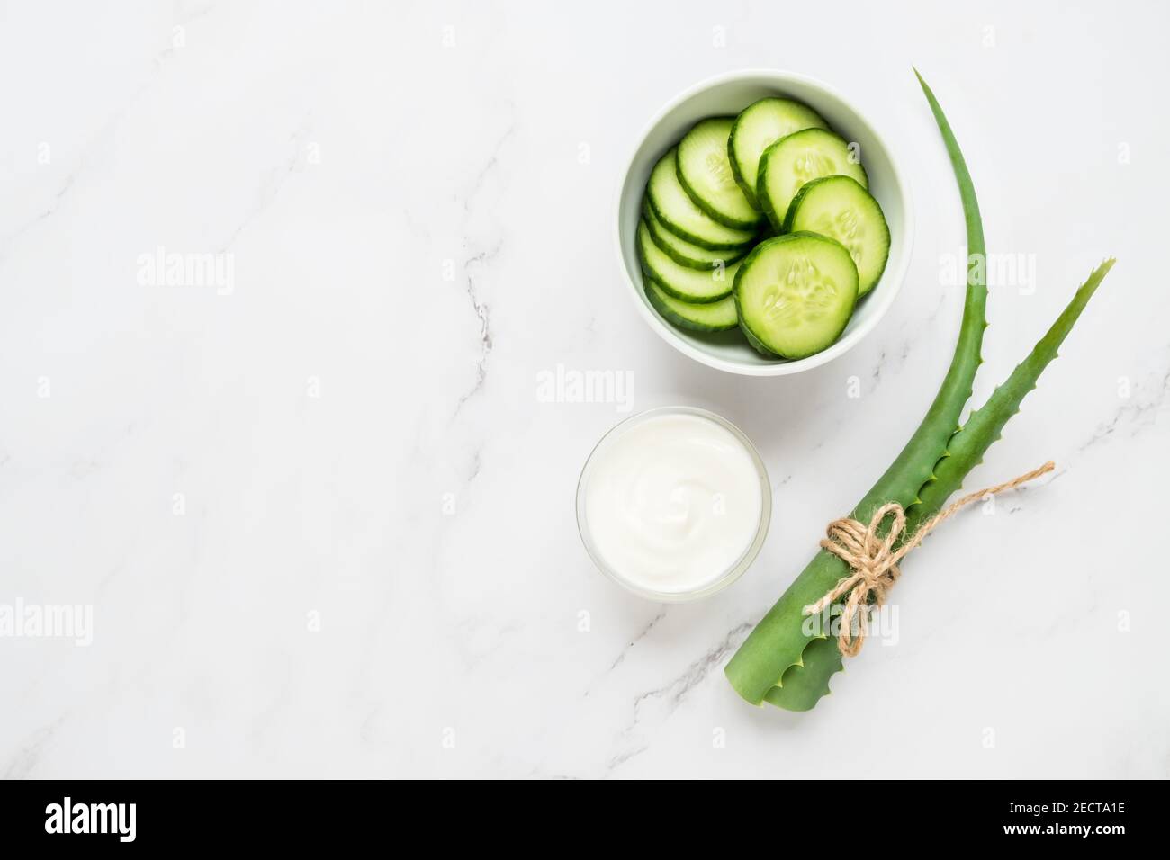 Homemade skin care concept. Green natural ingredients aloe vera, yogurt, cucumber for making a cosmetic mask on a light background Stock Photo