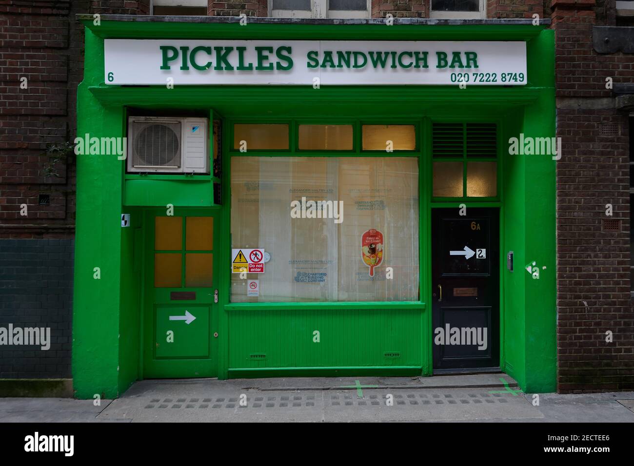 London UK 13 Feb 2021 Old looking sandwich shop with green front and
