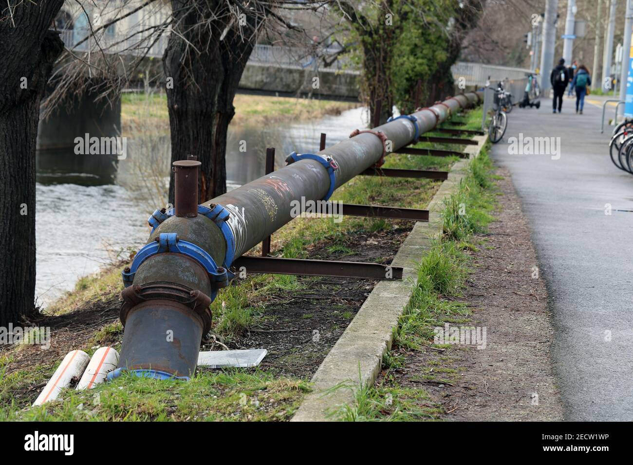 Old rustic old pipeline next to a walkway in downtown Zürich, Switzerland. Photographed during a cloudy spring day. Few people. Color image. Stock Photo