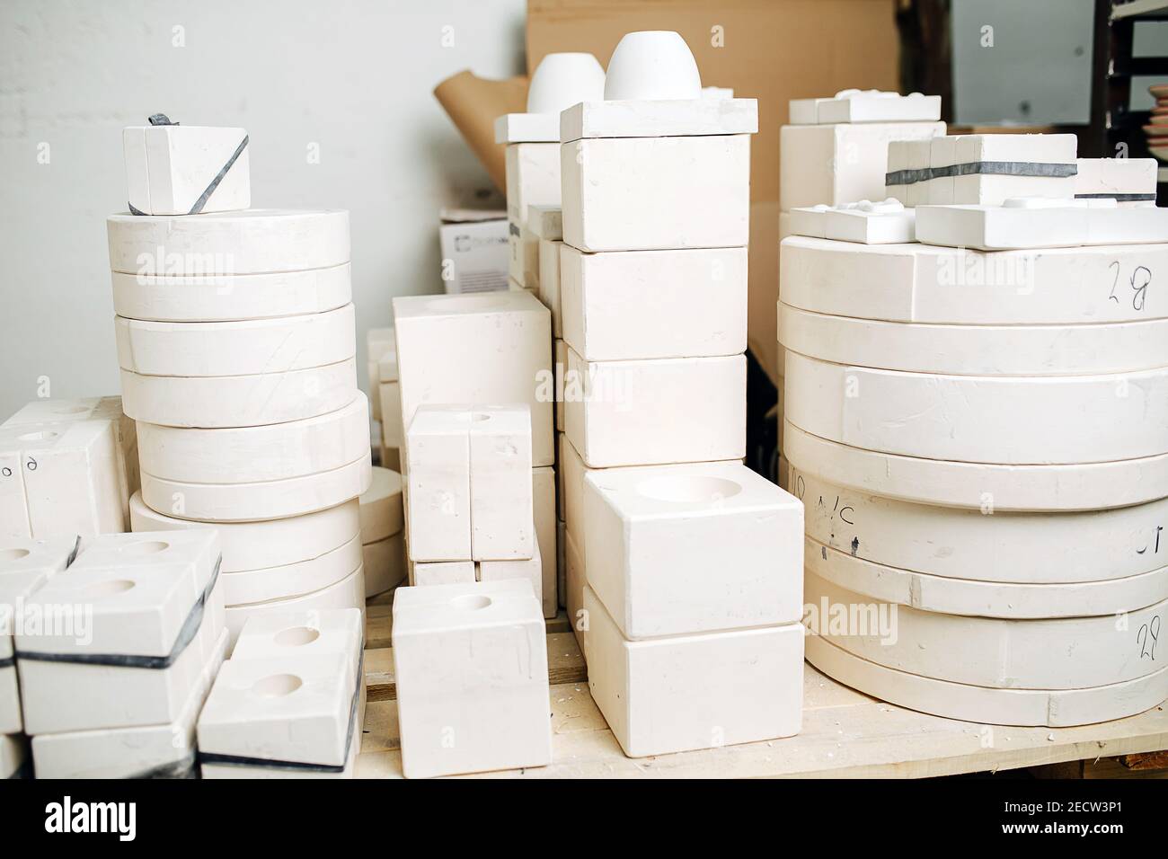 Stack of molds for casting tableware of different size and shape. Stock Photo