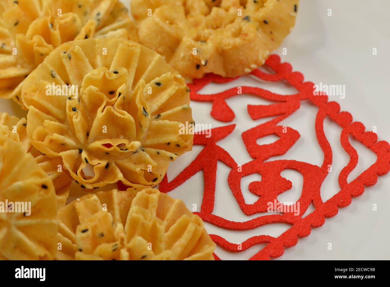 Kuih Rose are popular festive treats to celebrate Chinese New Year in Singapore & Malaysia, seen here with a red 'Fu' or 'Fortune' decoration Stock Photo