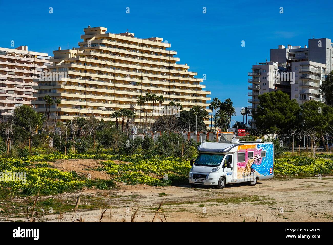Colourful camper van parked on waste ground, apartment blocks and palm  trees a the popular holiday destination of Calpe, Costa Blanca, Alicante,  Spain Stock Photo - Alamy