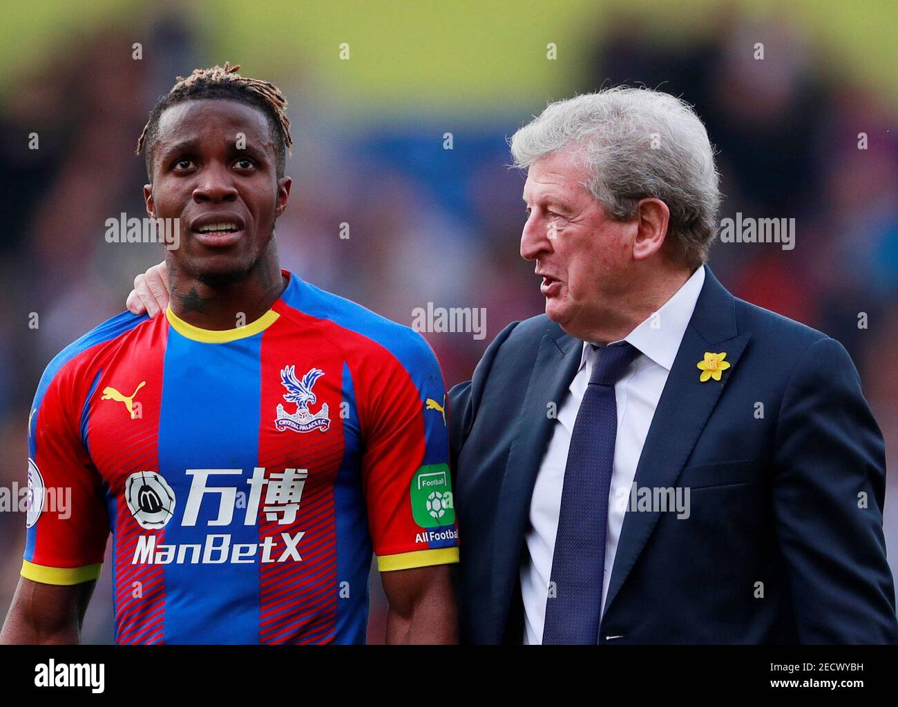 Soccer Football - Premier League - Crystal Palace v Huddersfield Town - Selhurst Park, London, Britain - March 30, 2019  Crystal Palace's Wilfried Zaha with manager Roy Hodgson after the match    Action Images via Reuters/Andrew Couldridge  EDITORIAL USE ONLY. No use with unauthorized audio, video, data, fixture lists, club/league logos or 'live' services. Online in-match use limited to 75 images, no video emulation. No use in betting, games or single club/league/player publications.  Please contact your account representative for further details. Stock Photo