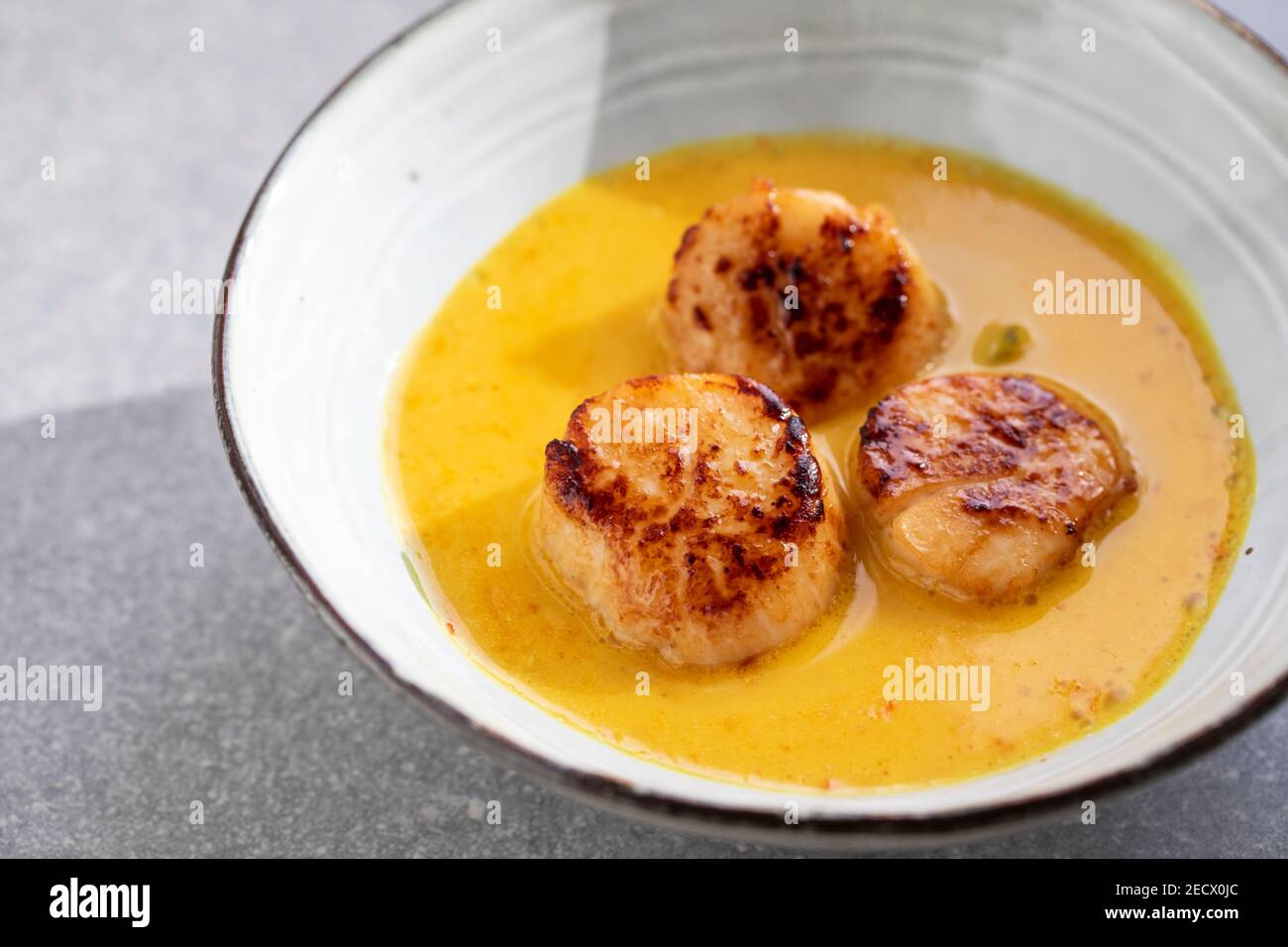 Scallops in spicy gulai sauce, Indonesian curry Stock Photo Alamy