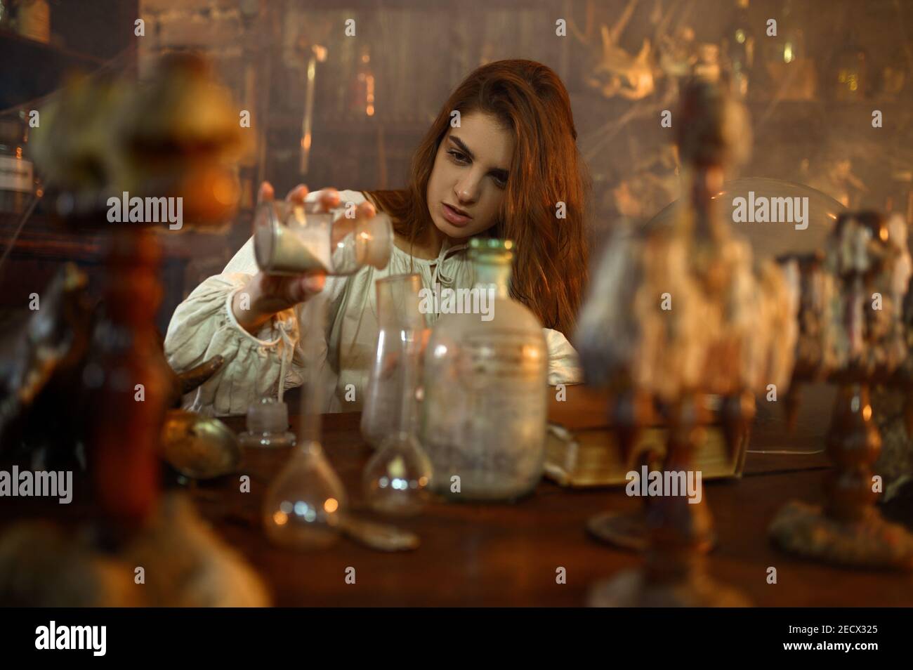 Demonic woman mixes potions, demons casting out Stock Photo