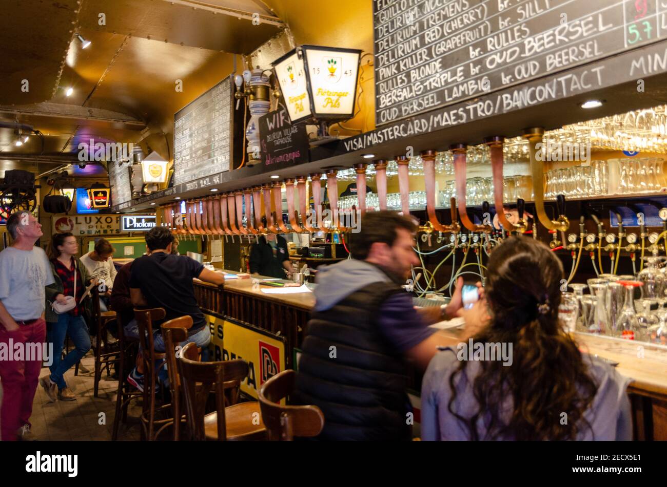 People drinking beer in the fameous Delirium Cafe in Brussels, Belgium