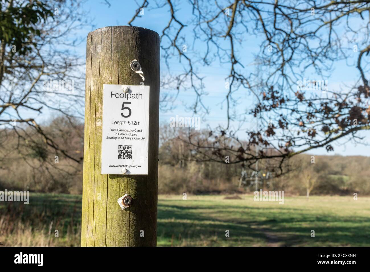 Country footpath walking route sign with a data matrix barcode or QR code, modern mobile phone technology, Winchfield, Hampshire, UK Stock Photo