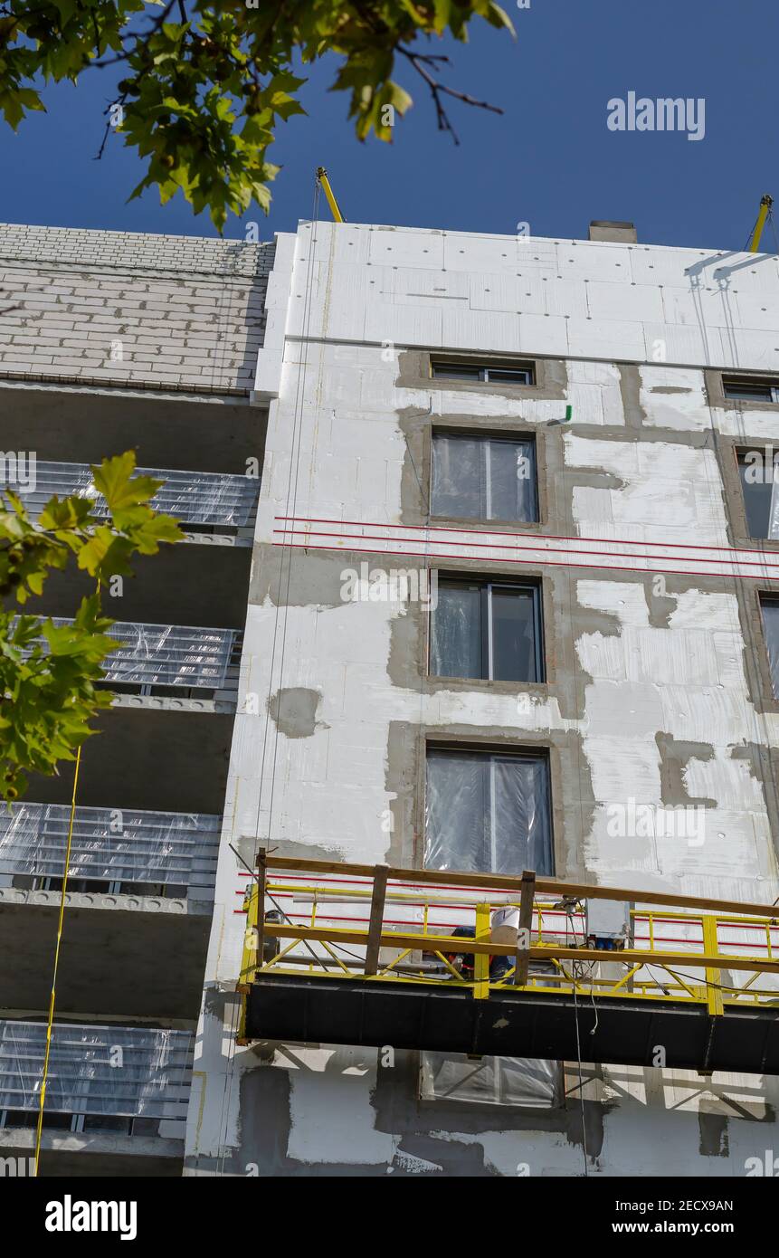 Thermal insulation of the walls of a new unfinished apartment building ...