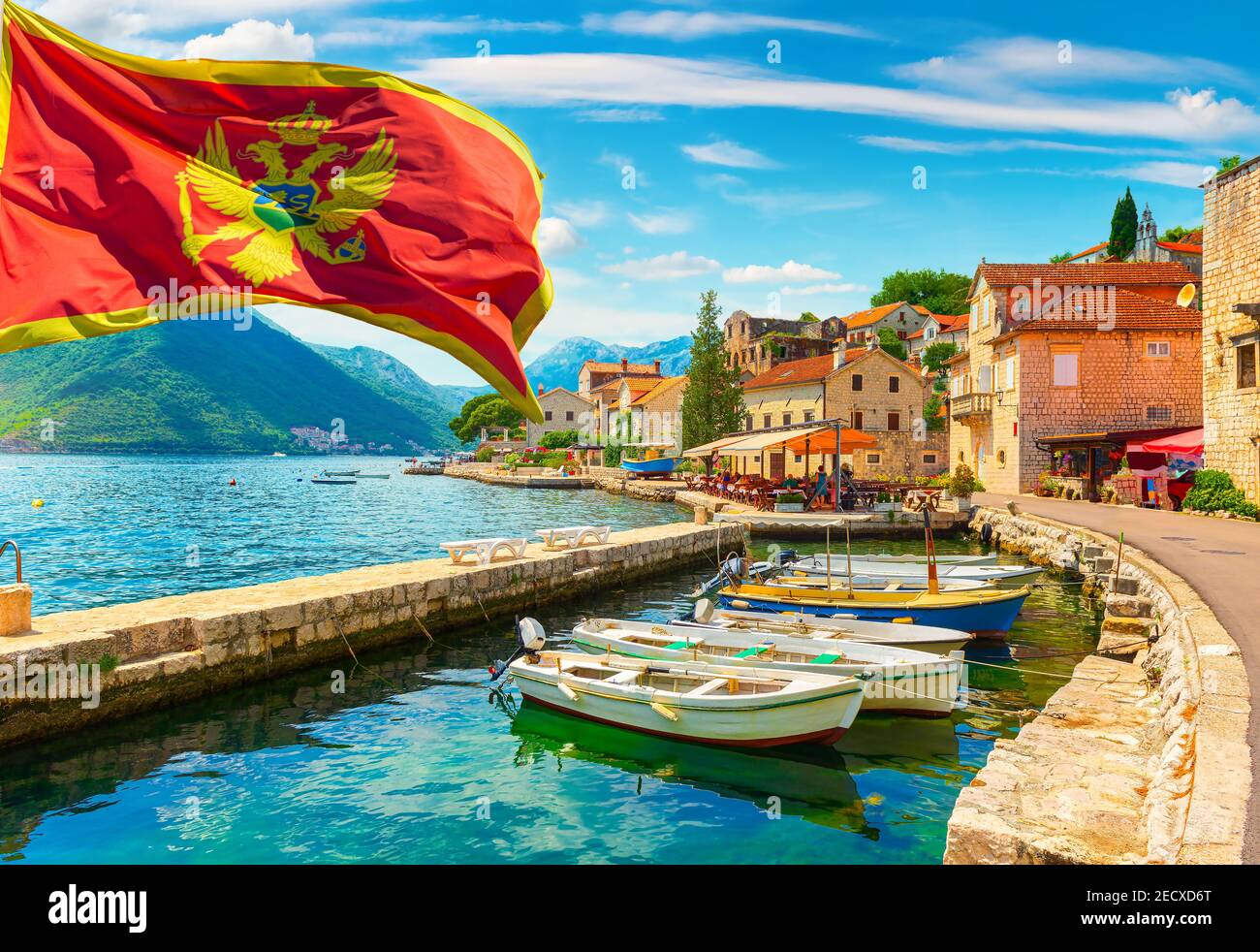 Flag and historic town of Perast at Bay of Kotor in summer, Montenegro Stock Photo