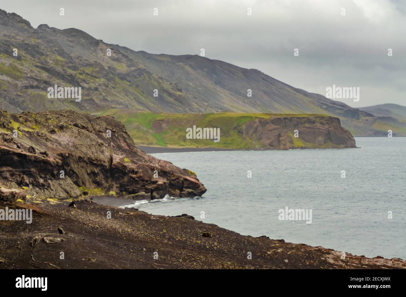 Icelandic nature landscape with a road next to a lake Stock Photo