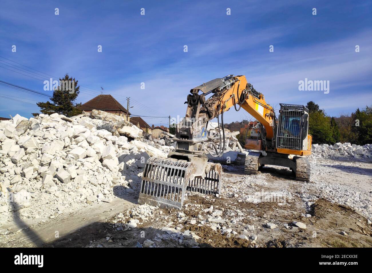 Building demolition for new construction, using a special hydraulic excavator-destroyer. Stock Photo