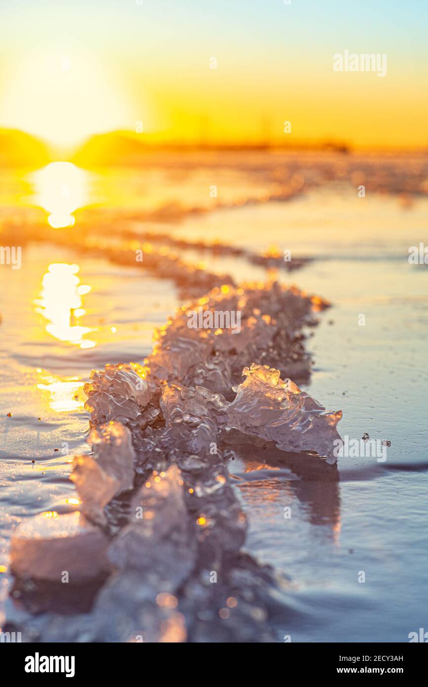 Sunset over a frozen body of water Stock Photo