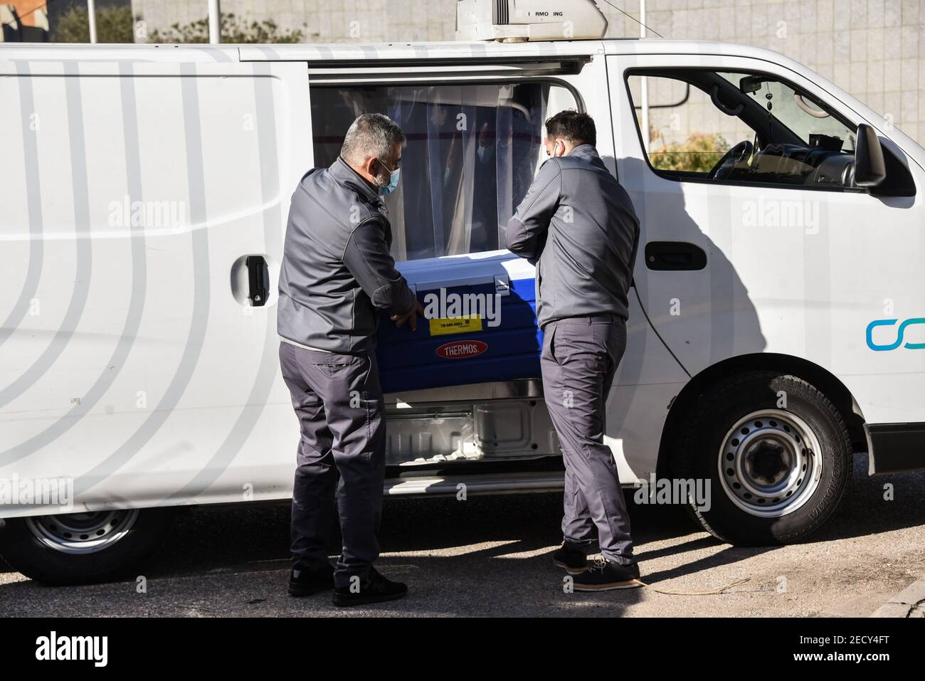 Beirut, Lebanon, 14 February, 2021. Men load a cool box filled with