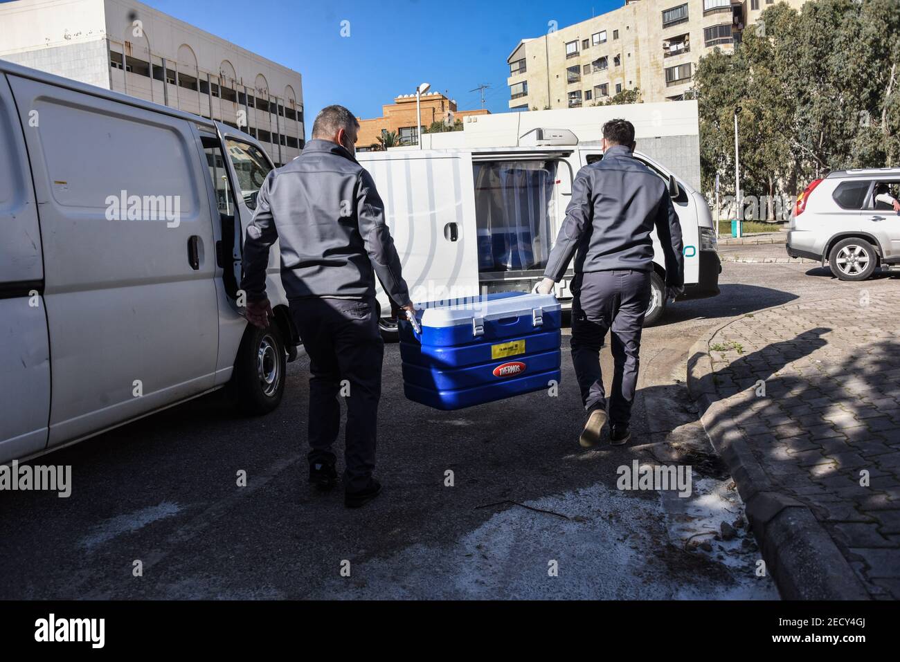 Beirut, Lebanon, 14 February, 2021. Men load a cool box filled with