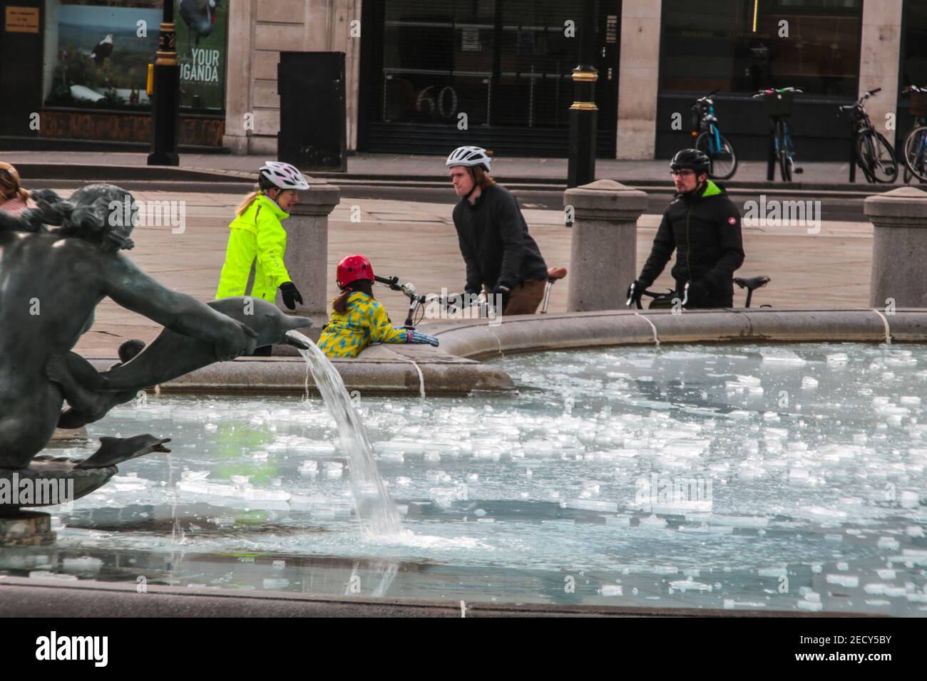 London UK 14 February 2021 People and families enjoying the frozen fountains in Trafalgar Square, were even the water was frozen today. Paul Quezada-Neiman/Alamy Live News Stock Photo