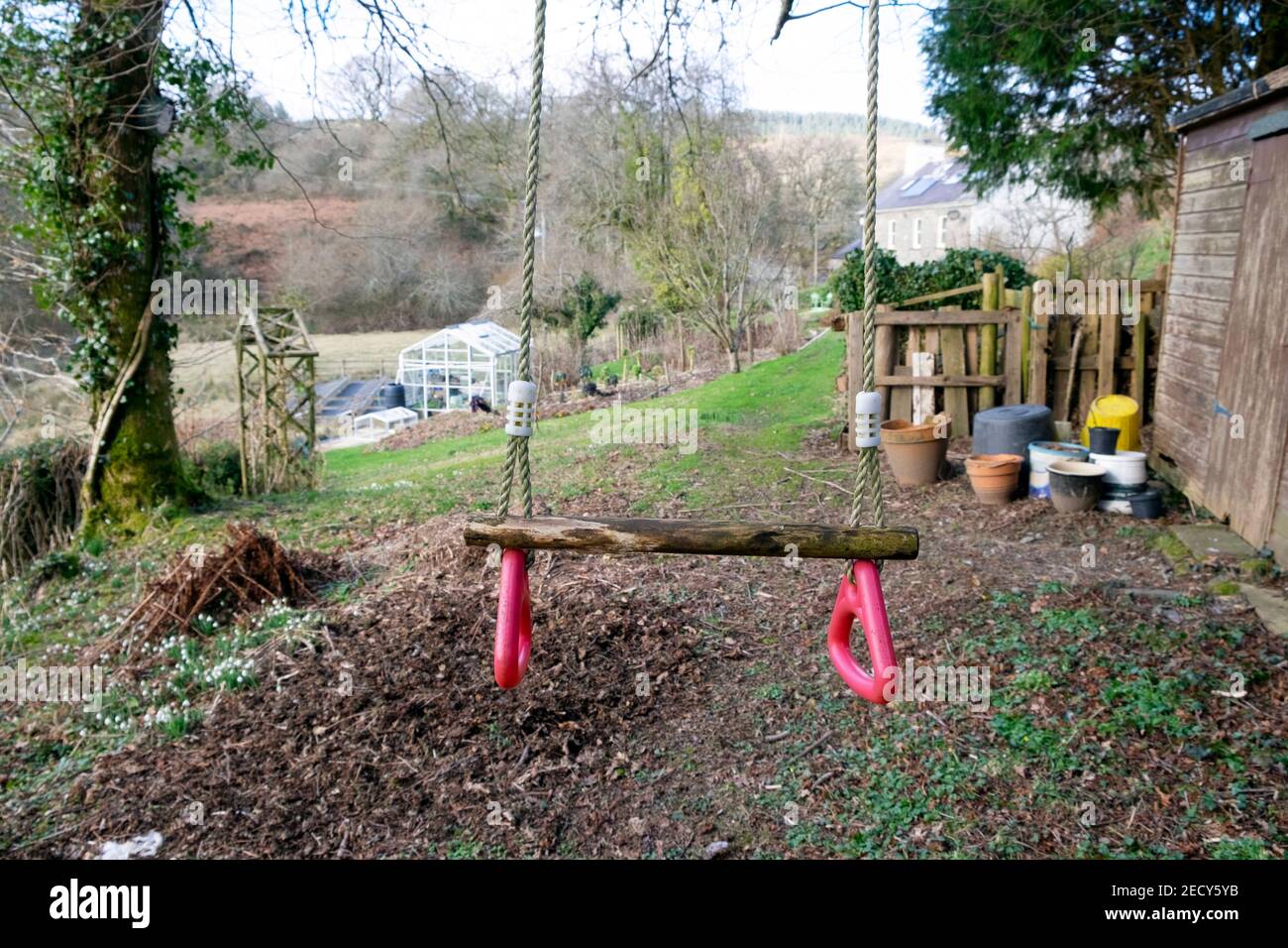 Empty garden swing in winter during covid 19 pandemic lockdown when children unable to visit grandparents in Carmarthenshire Wales UK. KATHY DEWITT Stock Photo