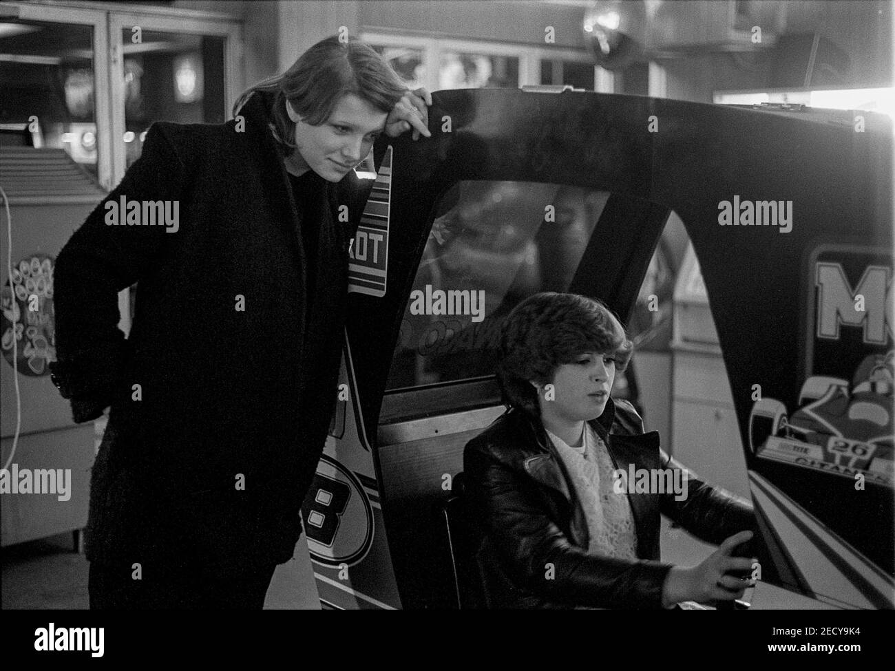 Two Teenage Girls playing Racing Machine Stock Photo