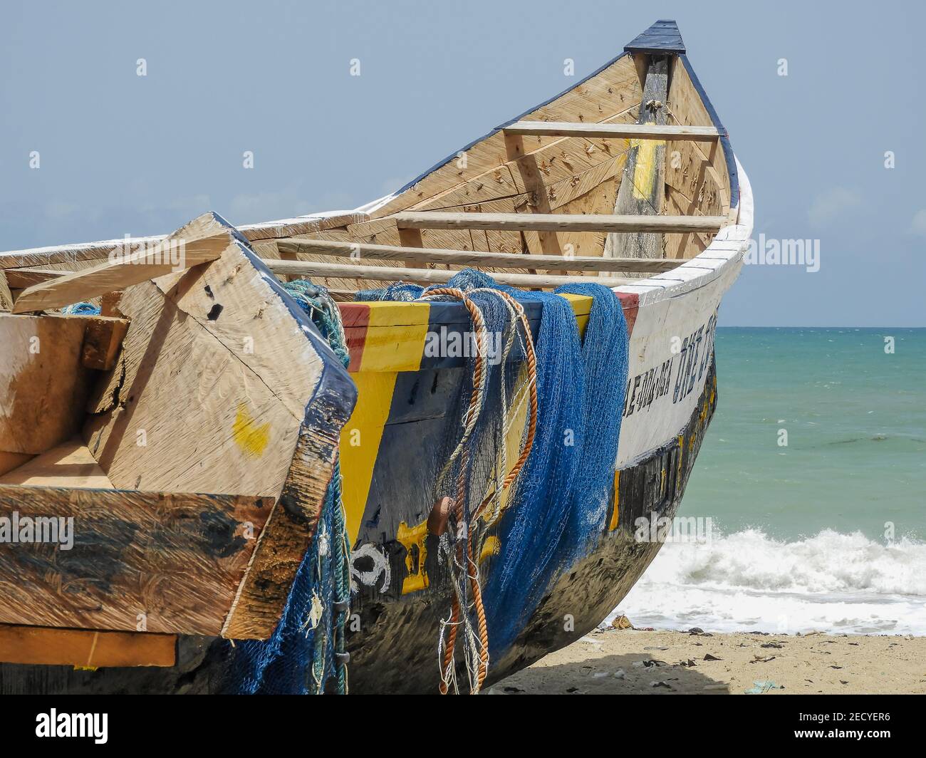 Africa Fishing boat with blue fishing nets in Ada Foah Ghana. Nice area with old traditional fishing. Stock Photo