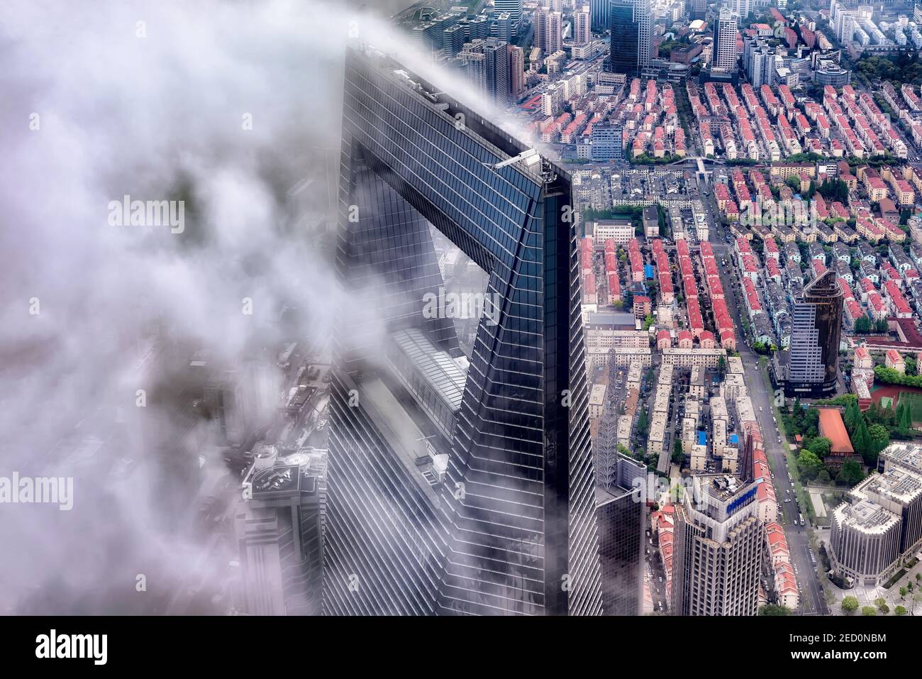 Shanghai, China - April 20, 2019: View of Shanghai World Financial Center emerging from clouds. The WFC  is a supertall skyscraper located in Pudong Stock Photo