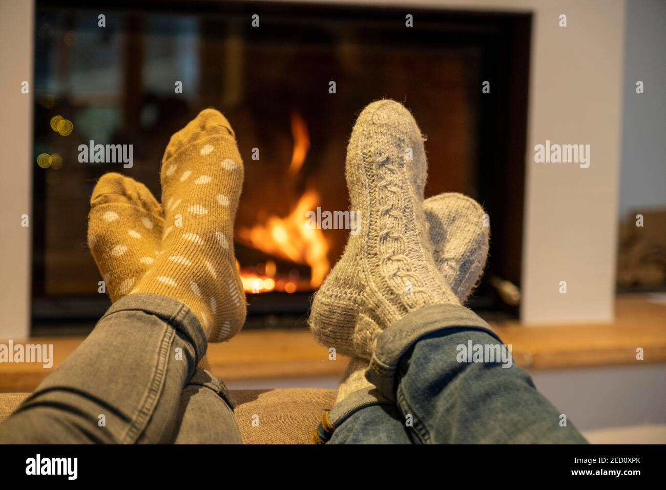 Feet with cuddly socks in front of a fireplace, winter, Bavaria, Germany Stock Photo