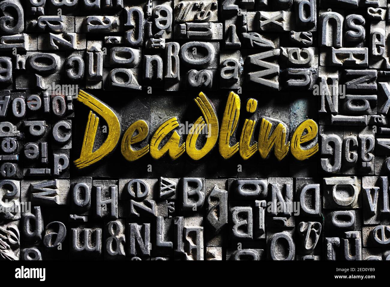 Old lead letters with golden writing, word Deadline Stock Photo