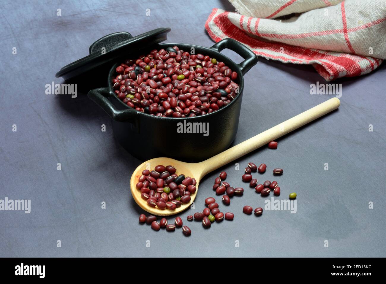 Dried beans in cast iron pot, cooking spoon, Germany Stock Photo