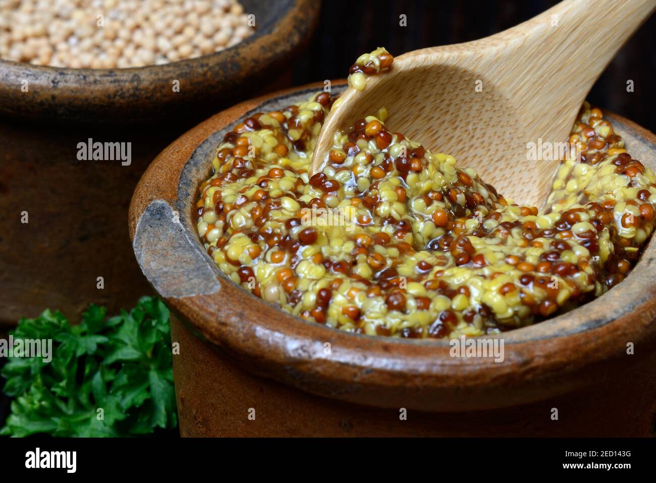 Coarsegrained Dijon mustard in pots, mustard seeds, France Stock Photo